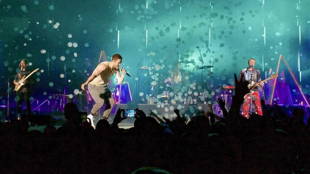 Imagine Dragons biography portrait — Dan Reynolds performing live in Uncasville.