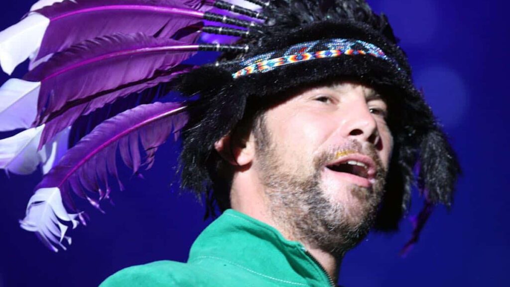 Jamiroquai biography portrait — Jay Kay performing live on stage in Sydney.
