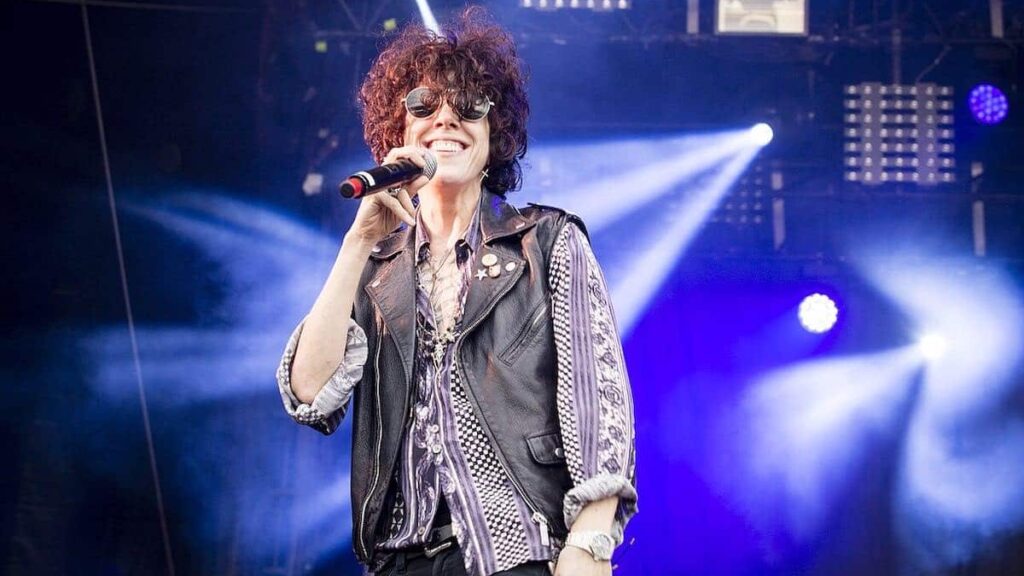 LP biography portrait — performing on stage at Lollapalooza Paris.