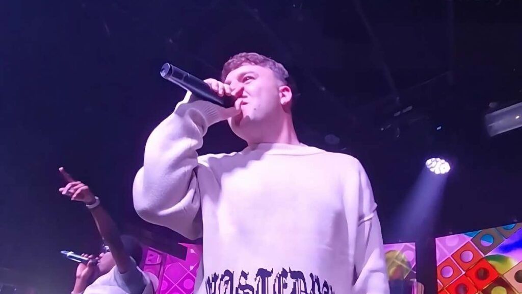 Quevedo biography portrait — performing live on stage in 2023.