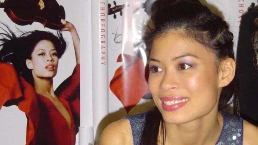 Vanessa-Mae biography portrait — performing live with her violin on stage.