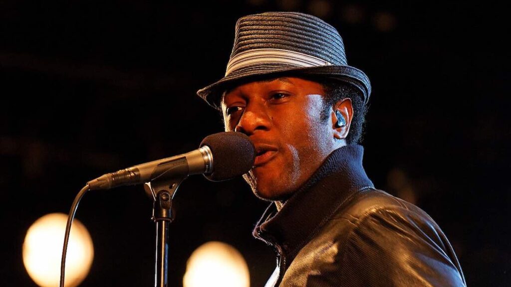 Aloe Blacc biography portrait — performing live on stage at the Festival du Bout du Monde in 2011.