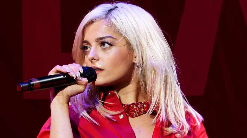 Bebe Rexha biography portrait — performing live on stage at Staples Center in Los Angeles.