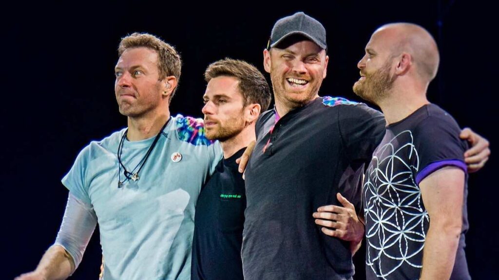 Coldplay biography portrait — legendary rock band performing at The Rose Bowl in 2017.