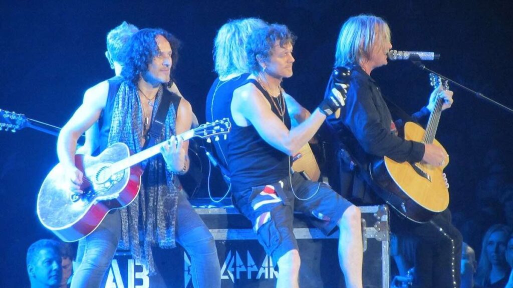 Def Leppard biography portrait — performing an acoustic set on stage at the Allstate Arena in 2012.
