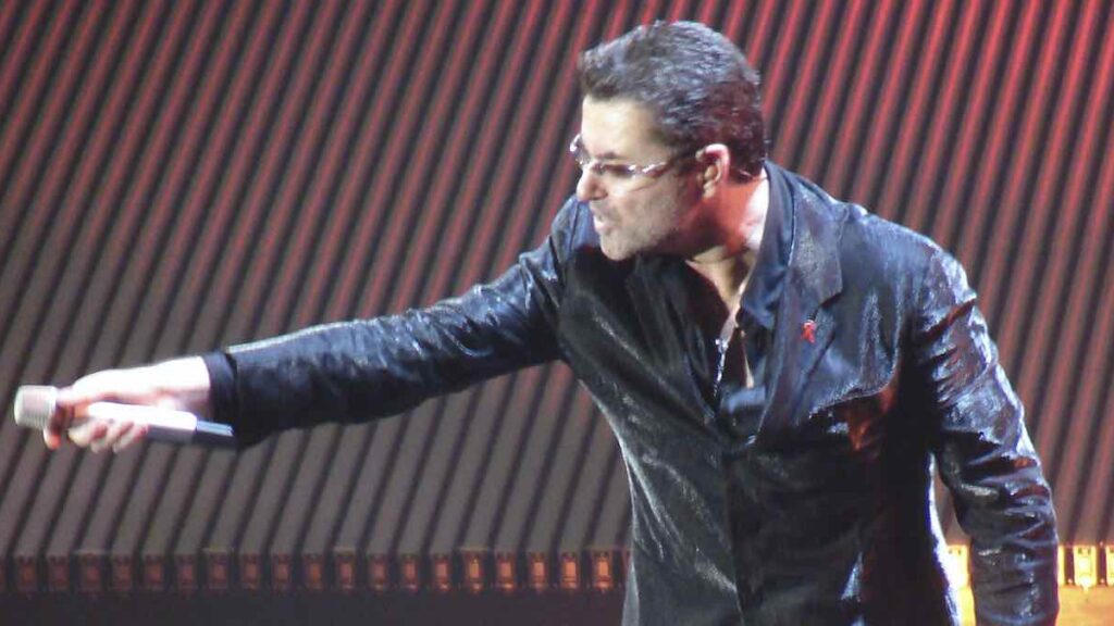 George Michael biography portrait — performing live on stage during a concert in Antwerp.