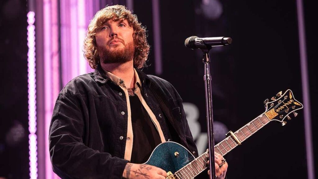 James Arthur biography portrait — performing on stage in 2024.