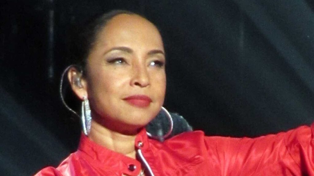 Sade Adu biography portrait — smiling close up during a concert in Germany.