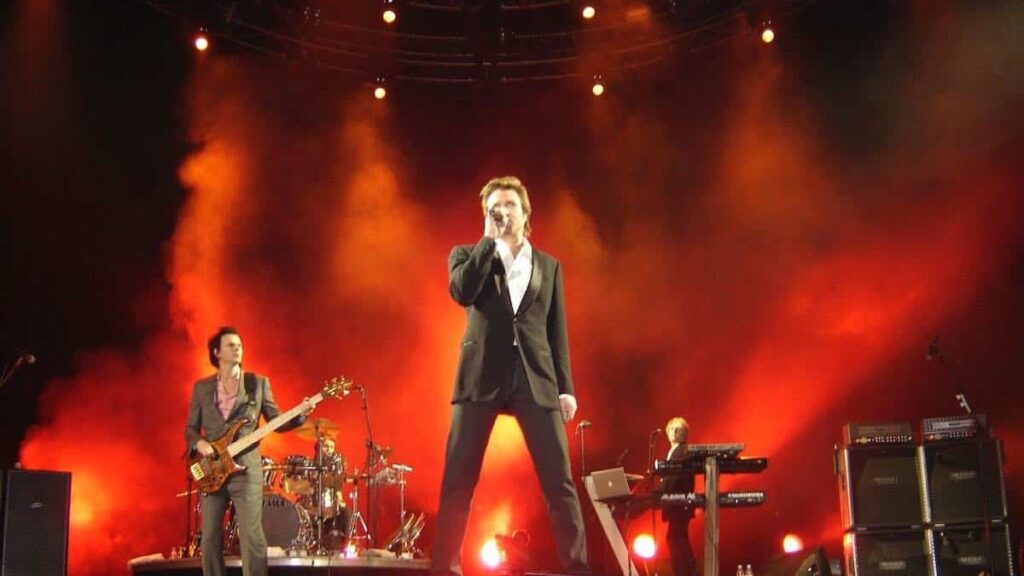 Duran Duran biography portrait — famous pop rock band performing live on stage.